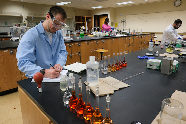 Student in lab taking notes