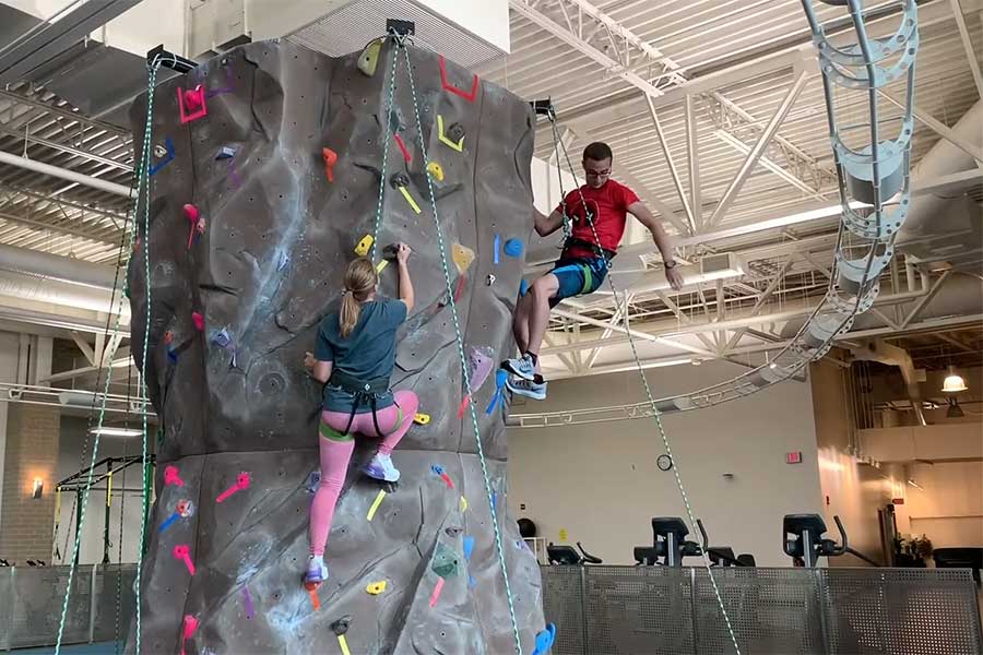 Still image of UREC tour showing students on the climbing tower