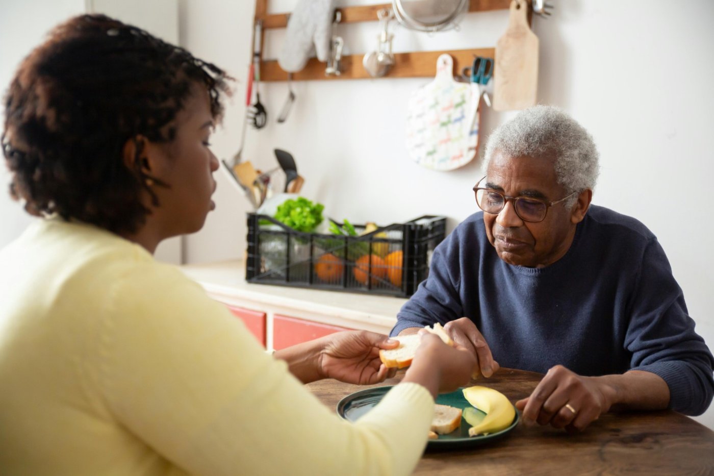 woman fixing an elderly man food