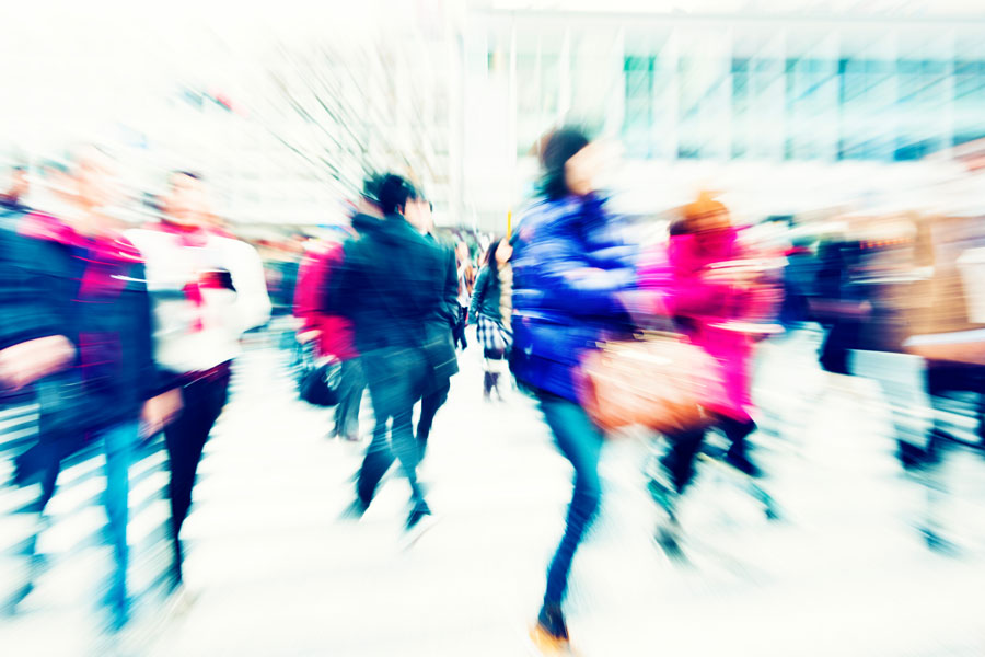 Blurred photo of people walking in the streets