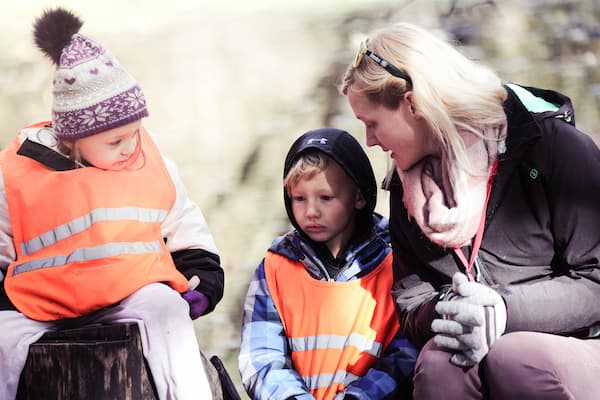 Student intern working with children outside