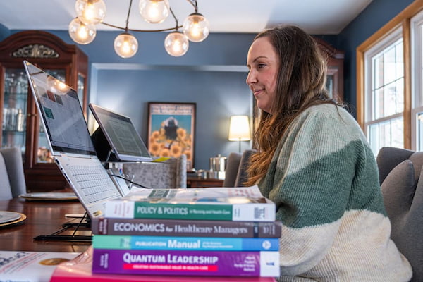 photo of students with textbooks during online class
