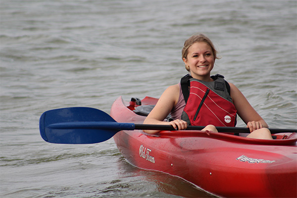 Student in a sea kayak wearing a life vest