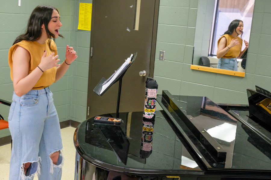 Student attending singing lessons with professor