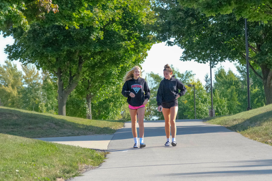 Two students walking together on campus