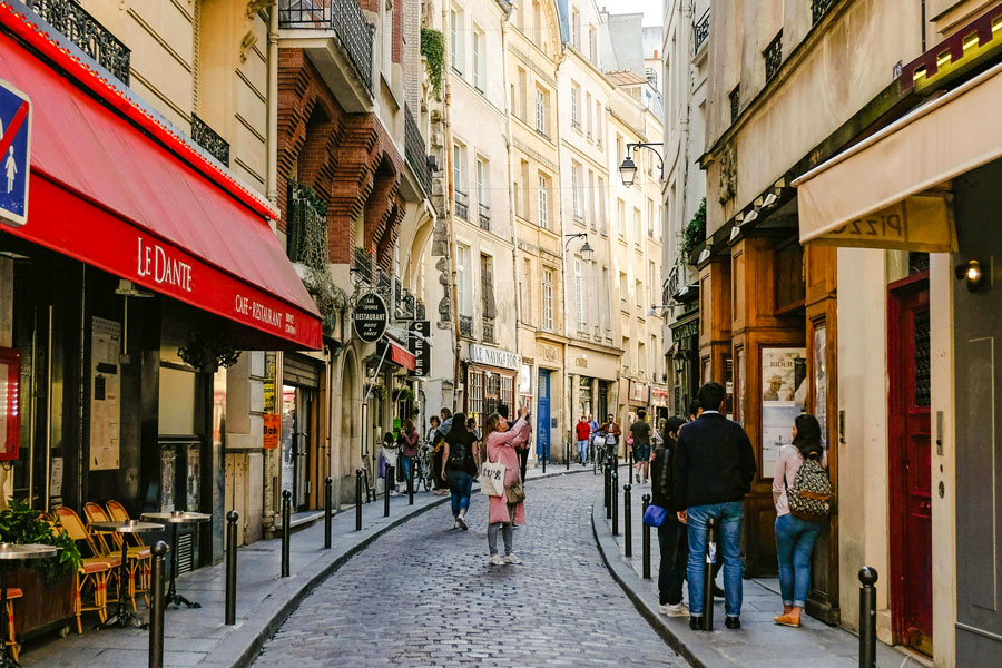 Tourist taking photo of french alleyway