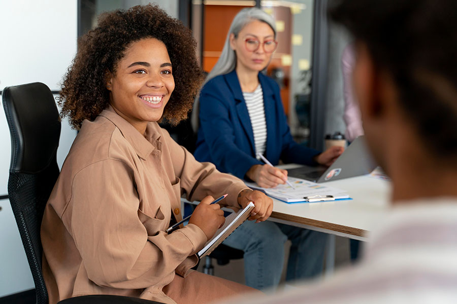 woman listening and smiling during a meeting