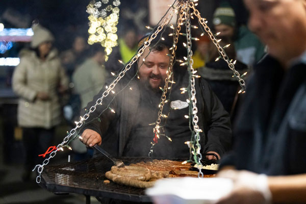 People grilling brats at German event event