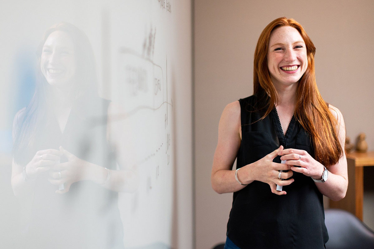 woman standing at a dry erase board