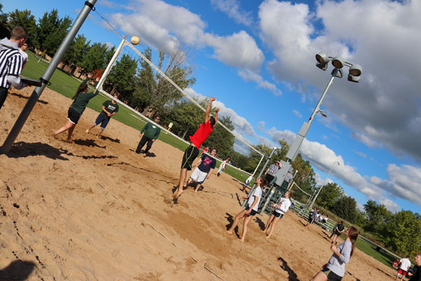 Students playing outdoor volleyball