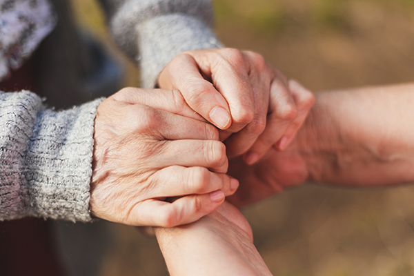 Pair of aging hands grasping each other