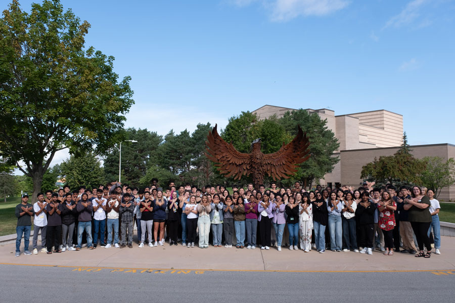 Photo of UW-Green Bay international studies in front of Phoenix Sculpture