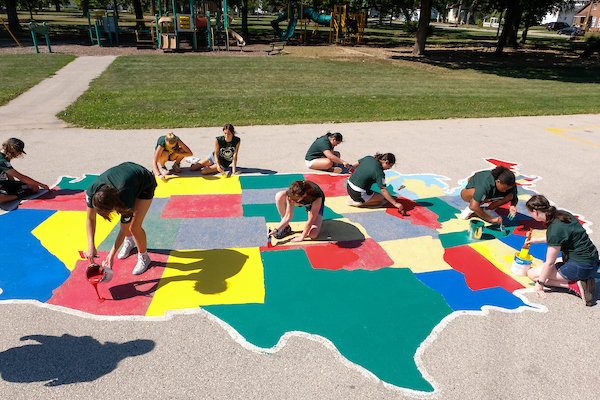 UW-Green Bay students painting mural of the United States