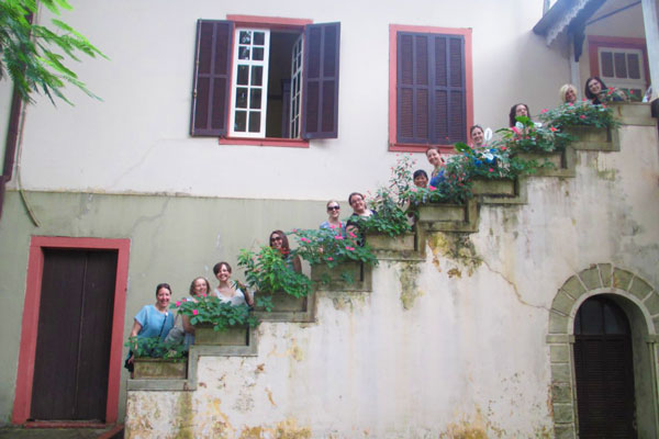 Students standing on stairs of old house