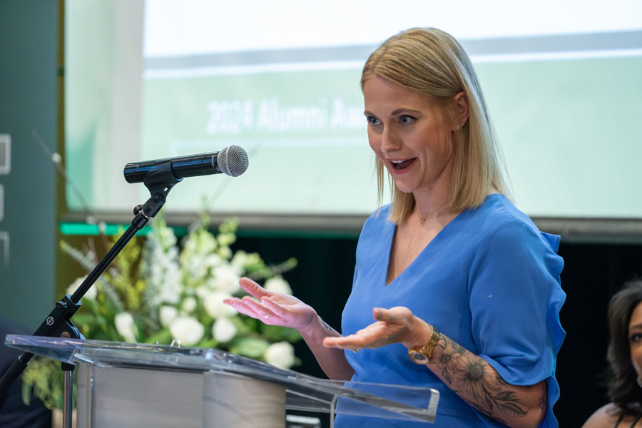 Woman gives speech at alumni awards event