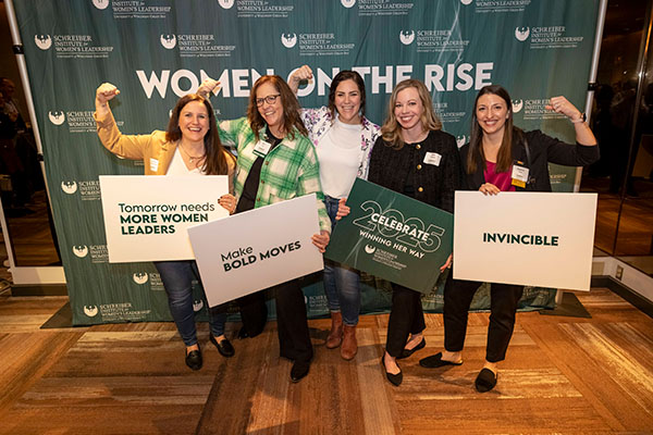 group of five women making the Accelerate Action pose