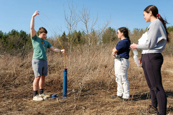 Students participate in well digging