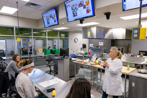 Professor teaching class in UW-Green Bay's industrial kitchen