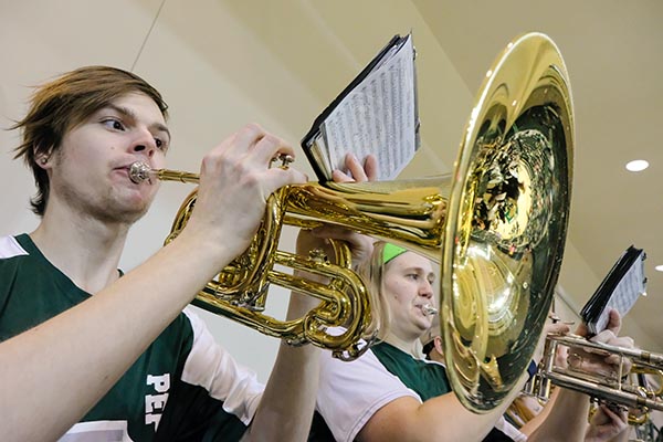 Student playing mellophone at basketball game