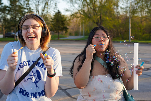 Students outside blowing bubbles