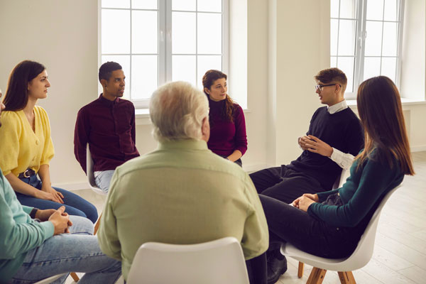 Community members attend group therapy