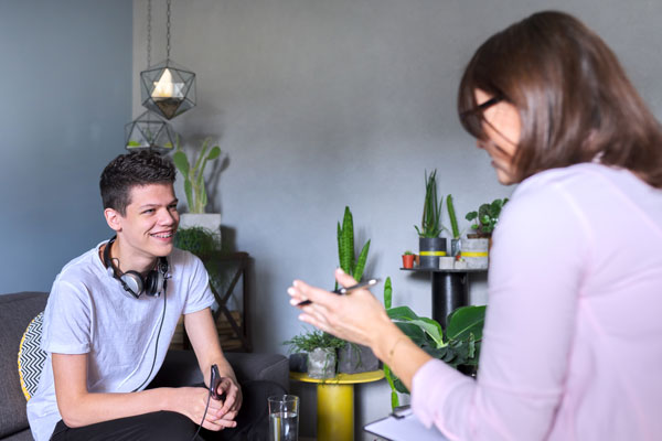 Teenage boy speaking with therapist