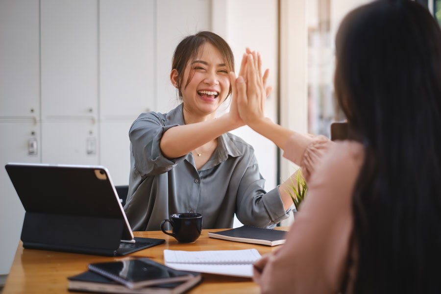 Two people giving each other high five