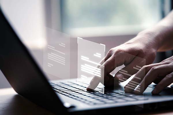 closeup of hands on laptop keyboard, virtual resources concept