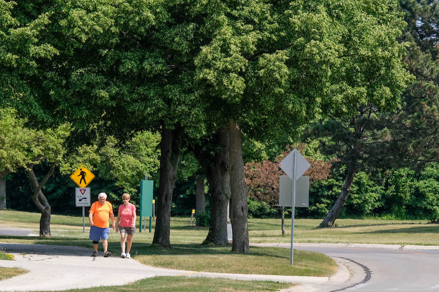 Older couple walking on campus