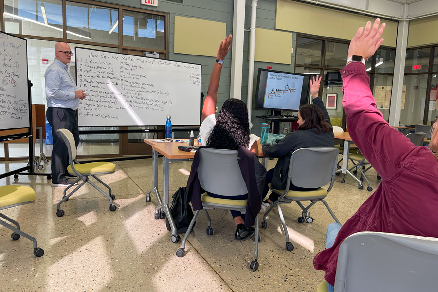 People raising their hands in a behavioral health trainging class