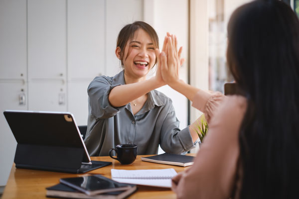 Two people give each other high five