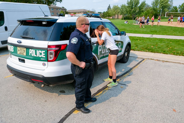 Student looking inside University Police squad car