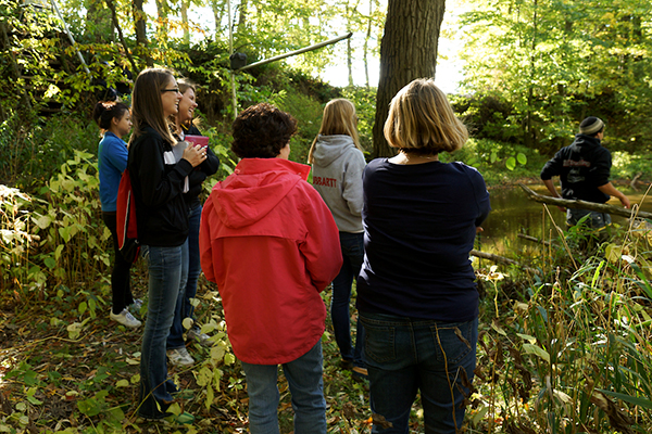 Students and teacher near creek