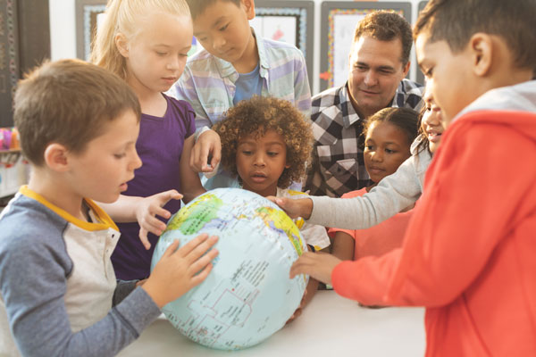 Teacher showing students globe