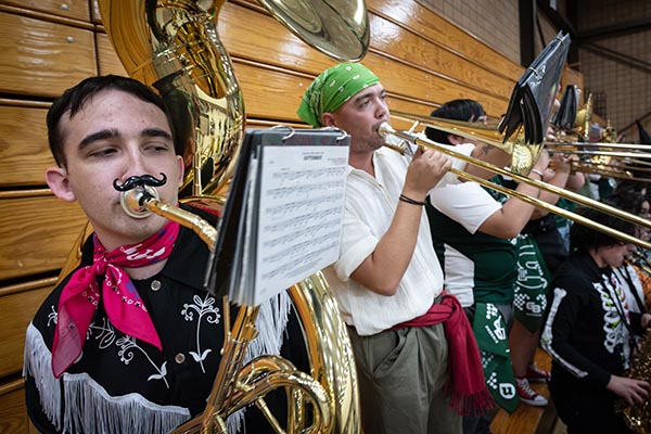 Students in costume playing tuba and trombone