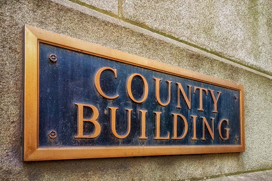 county building sign on side of brick building