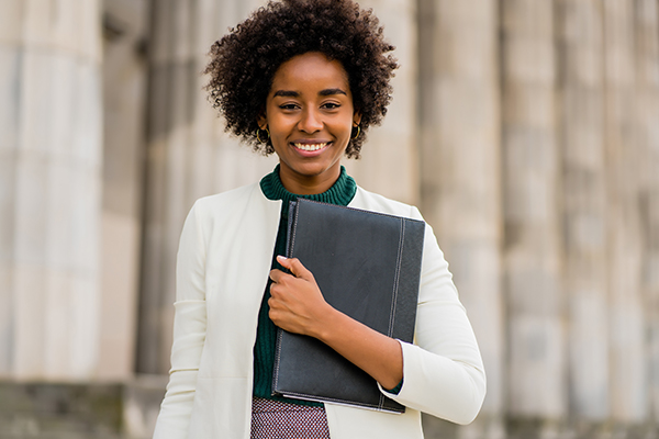 Young, african american professional with notebook outdoors