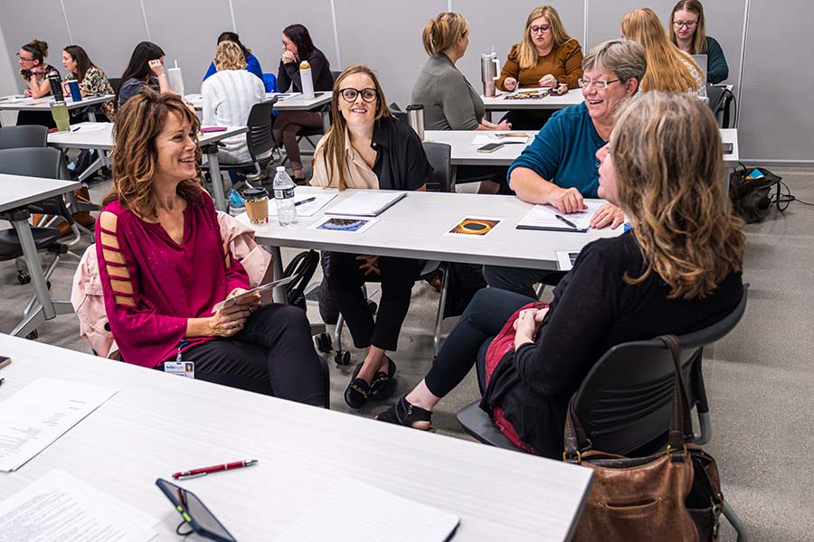 group of people in classroom working in small groups